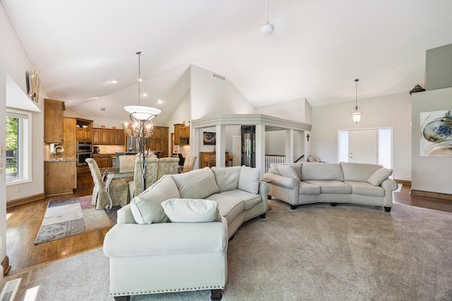 13703 47th St NE, Saint Michael, MN 55376 - living room with wood finished floors, high vaulted ceiling, and a chandelier