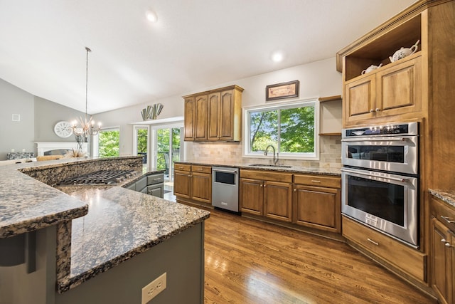 13703 47th St NE, Saint Michael, MN 55376 - kitchen with appliances with stainless steel finishes, open shelves, a chandelier, backsplash, and dark wood-type flooring