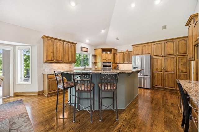13703 47th St NE, Saint Michael, MN 55376 - kitchen with appliances with stainless steel finishes, lofted ceiling, backsplash, light stone counters, and recessed lighting