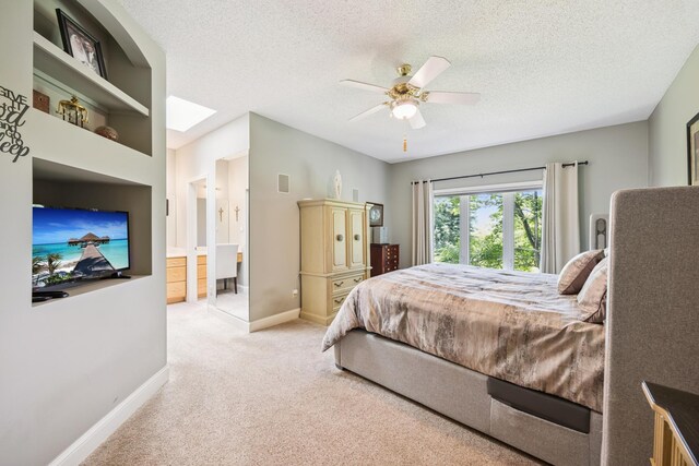 13703 47th St NE, Saint Michael, MN 55376 - bedroom featuring light colored carpet, a textured ceiling, ceiling fan, ensuite bathroom, and a skylight