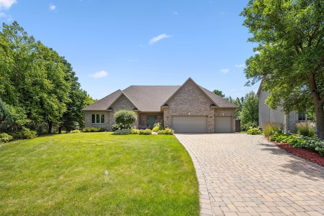 13703 47th St NE, Saint Michael, MN 55376 - view of front of house featuring an attached garage, a front lawn, decorative driveway, and brick siding