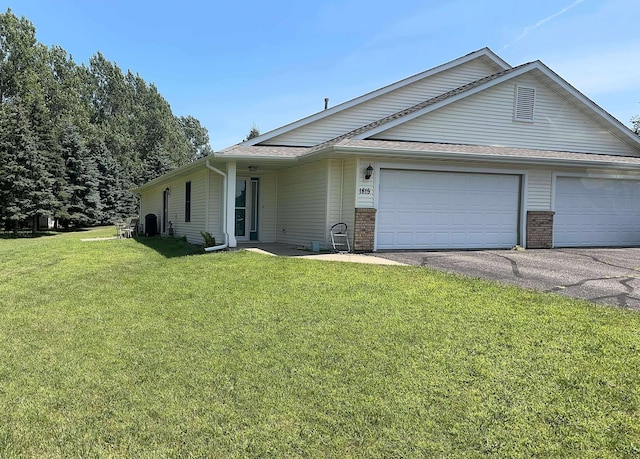 1815 Wooden Shoe Ct, Baldwin, WI 54002 - single story home with asphalt driveway, roof with shingles, a front yard, an attached garage, and brick siding