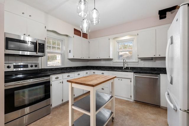 506 6th Ave SW, Austin, MN 55912 - kitchen featuring appliances with stainless steel finishes, plenty of natural light, and decorative backsplash