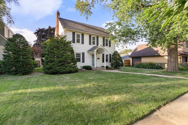 506 6th Ave SW, Austin, MN 55912 - colonial house with a chimney, a front yard, and a garage