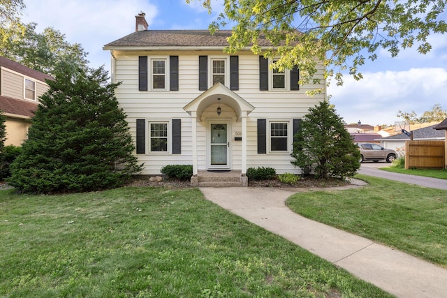 506 6th Ave SW, Austin, MN 55912 - colonial inspired home with a chimney and a front yard