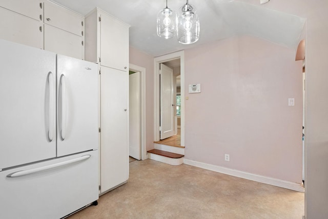 506 6th Ave SW, Austin, MN 55912 - kitchen with freestanding refrigerator, finished concrete flooring, white cabinets, and hanging light fixtures