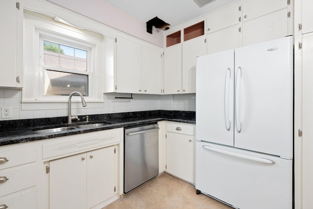 506 6th Ave SW, Austin, MN 55912 - kitchen with freestanding refrigerator, dishwasher, backsplash, dark stone counters, and white cabinetry