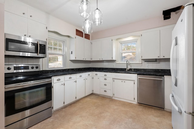 506 6th Ave SW, Austin, MN 55912 - kitchen featuring appliances with stainless steel finishes, decorative backsplash, and plenty of natural light