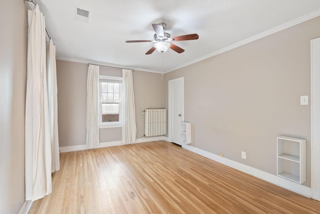 506 6th Ave SW, Austin, MN 55912 - empty room featuring radiator heating unit, a ceiling fan, light wood-style floors, and crown molding