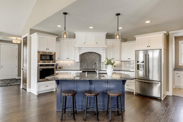 3163 Christopher Ln, Shoreview, MN 55126 - kitchen with stainless steel appliances, dark wood-style flooring, dark stone countertops, white cabinetry, and backsplash