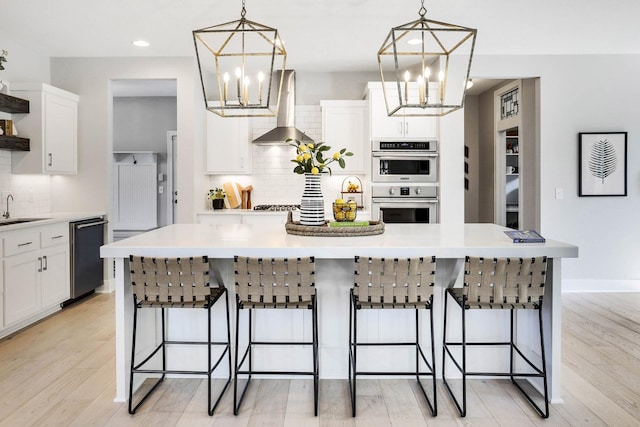 3163 Christopher Ln, Shoreview, MN 55126 - kitchen featuring island range hood, a chandelier, dishwashing machine, white cabinets, and recessed lighting