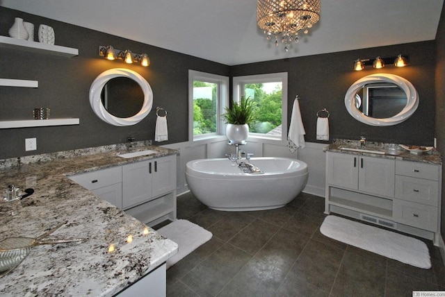 3163 Christopher Ln, Shoreview, MN 55126 - bathroom with two vanities, a freestanding tub, a chandelier, tile patterned flooring, and lofted ceiling