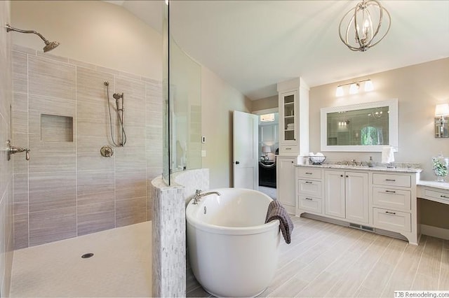 3163 Christopher Ln, Shoreview, MN 55126 - bathroom featuring a walk in shower, vanity, a freestanding bath, and vaulted ceiling