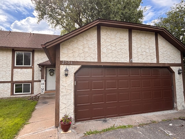 2905 Flag Ave N, New Hope, MN 55427 - view of front of house with a garage, roof with shingles, stone siding, and driveway