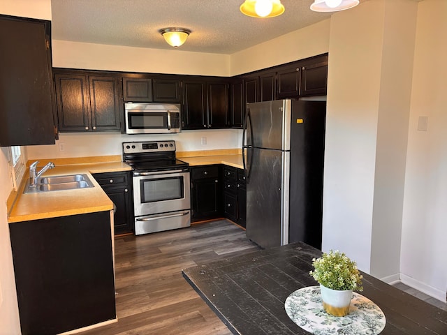 2905 Flag Ave N, New Hope, MN 55427 - kitchen with stainless steel appliances, dark wood-style floors, light countertops, and a textured ceiling