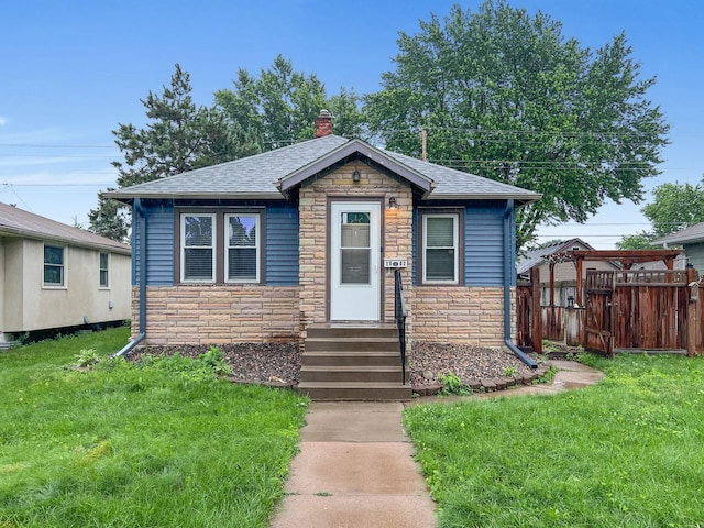 1502 Maywood St, Saint Paul, MN 55117 - bungalow-style house featuring stone siding, entry steps, roof with shingles, and a chimney