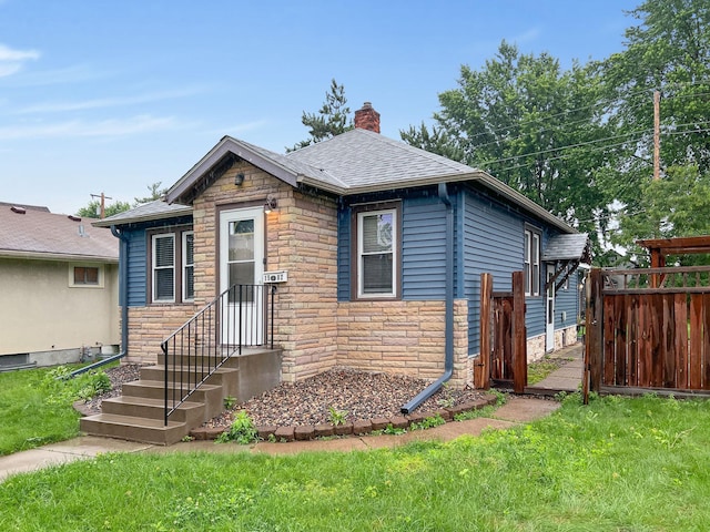 1502 Maywood St, Saint Paul, MN 55117 - view of front of property with stone siding, a chimney, and a shingled roof