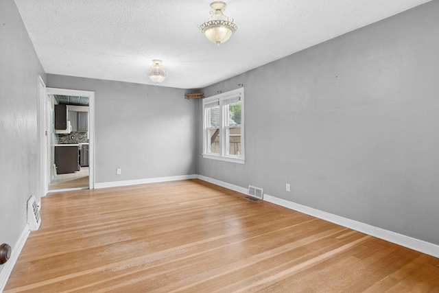 1502 Maywood St, Saint Paul, MN 55117 - unfurnished room with light wood-style flooring and a textured ceiling