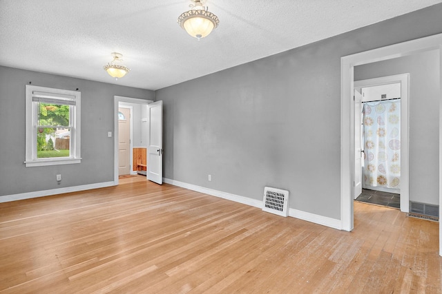 1502 Maywood St, Saint Paul, MN 55117 - spare room with light wood finished floors and a textured ceiling