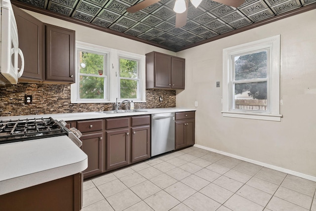 1502 Maywood St, Saint Paul, MN 55117 - kitchen featuring stainless steel dishwasher, white microwave, decorative backsplash, light countertops, and ceiling fan