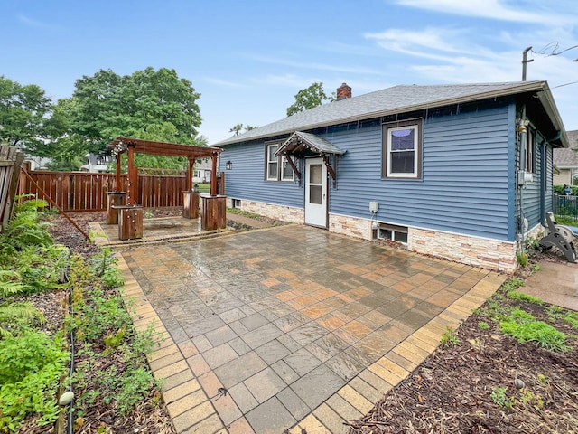 1502 Maywood St, Saint Paul, MN 55117 - back of house with a patio, stone siding, a chimney, and a pergola