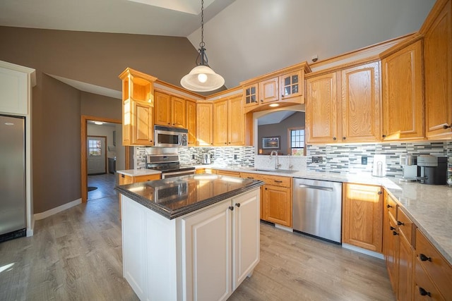 35337 County 24th Blvd, Warsaw Twp, MN 55009 - kitchen with stainless steel appliances, backsplash, glass insert cabinets, light wood-style floors, and decorative light fixtures
