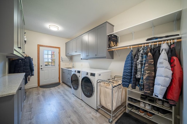 35337 County 24th Blvd, Warsaw Twp, MN 55009 - washroom featuring cabinet space, washing machine and clothes dryer, and light wood-type flooring