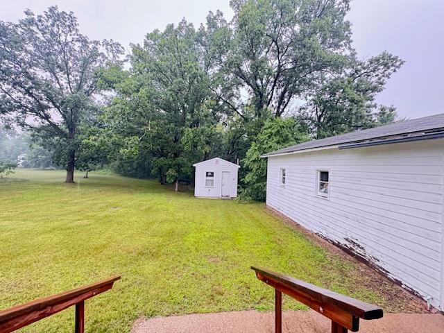317 2nd St NE, Menahga, MN 56464 - view of grassy yard with a storage unit