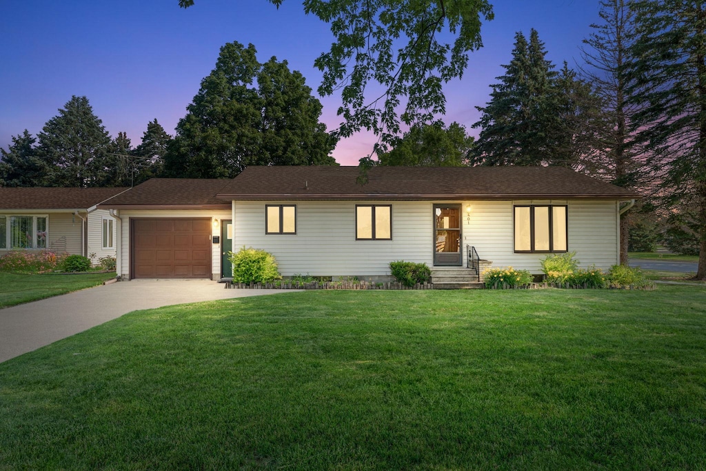 401 Douglas St, Arlington, MN 55307 - single story home featuring a garage, concrete driveway, and a front lawn
