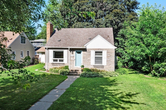 5712 Grand Ave S, Minneapolis, MN 55419 - view of front of home featuring a front lawn, a chimney, stone siding, and roof with shingles