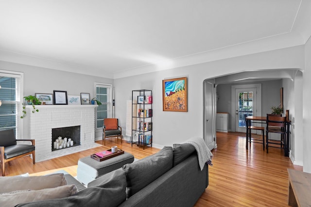5712 Grand Ave S, Minneapolis, MN 55419 - living area with light wood-type flooring, arched walkways, and a brick fireplace