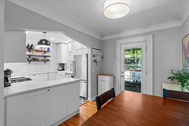 5712 Grand Ave S, Minneapolis, MN 55419 - kitchen featuring stainless steel appliances, open shelves, white cabinetry, light wood-style floors, and light countertops