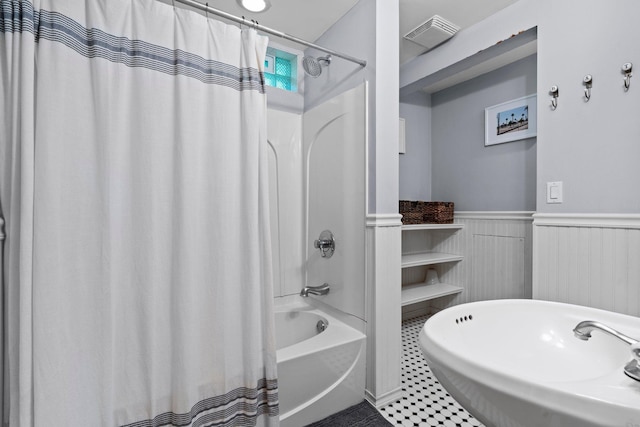 5712 Grand Ave S, Minneapolis, MN 55419 - full bath with shower / bath combo, wainscoting, and tile patterned flooring