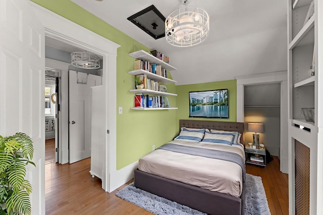3502 Grand Ave S, Minneapolis, MN 55408 - bedroom with hardwood / wood-style floors and a chandelier