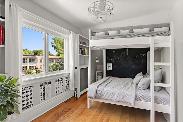 3502 Grand Ave S, Minneapolis, MN 55408 - bedroom featuring wood-type flooring and a chandelier