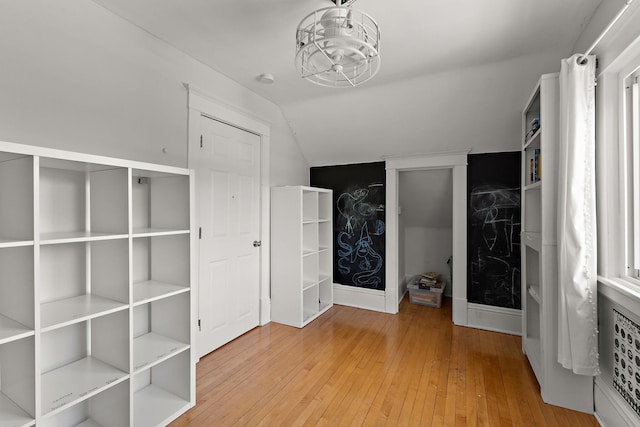 3502 Grand Ave S, Minneapolis, MN 55408 - unfurnished bedroom with lofted ceiling and wood-type flooring