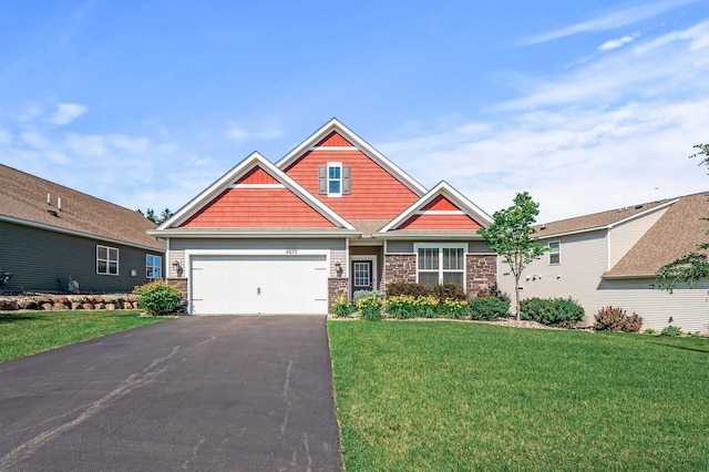 4870 Copper Ridge Dr, Woodbury, MN 55129 - craftsman inspired home featuring stone siding, asphalt driveway, a front yard, and a garage