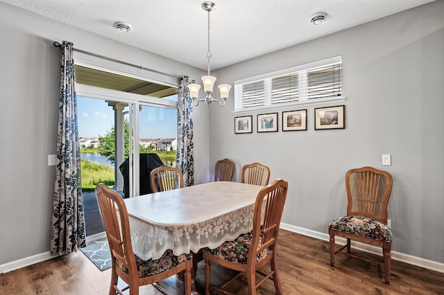4870 Copper Ridge Dr, Woodbury, MN 55129 - dining space featuring a chandelier and wood finished floors