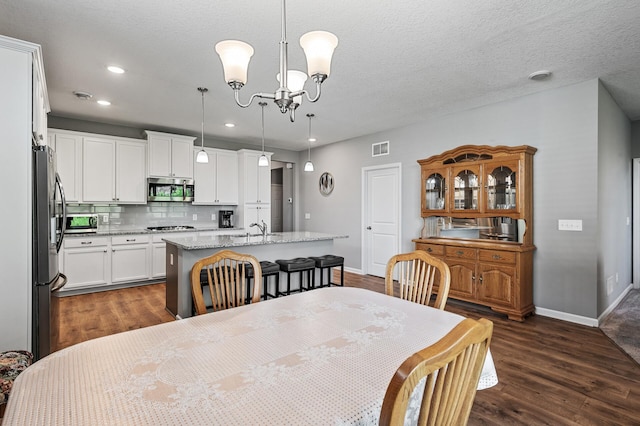 4870 Copper Ridge Dr, Woodbury, MN 55129 - dining area with dark wood-style floors, a chandelier, and recessed lighting