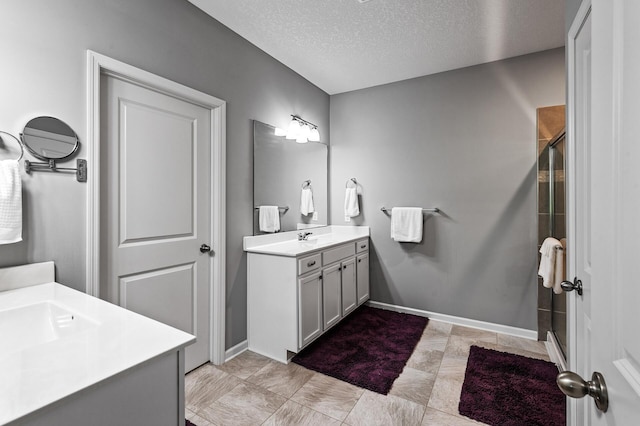 4870 Copper Ridge Dr, Woodbury, MN 55129 - bathroom featuring two vanities, a textured ceiling, and a stall shower