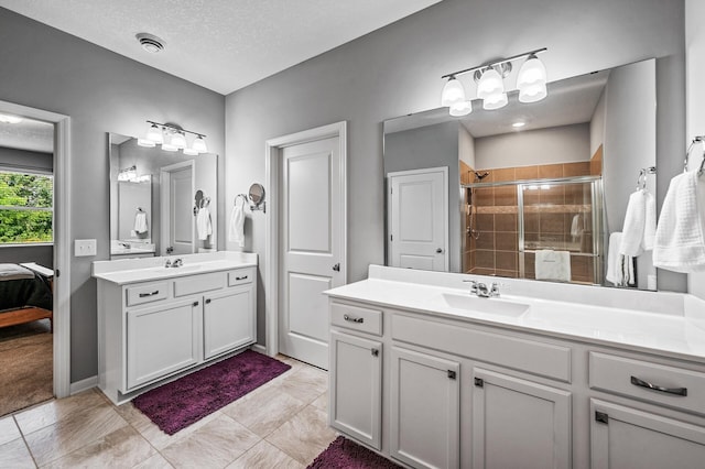 4870 Copper Ridge Dr, Woodbury, MN 55129 - ensuite bathroom with two vanities, a stall shower, and a textured ceiling
