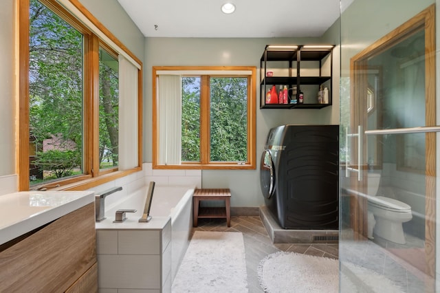 1610 63rd St, Chanhassen, MN 55331 - full bath featuring washer / dryer, a garden tub, vanity, tile patterned floors, and recessed lighting