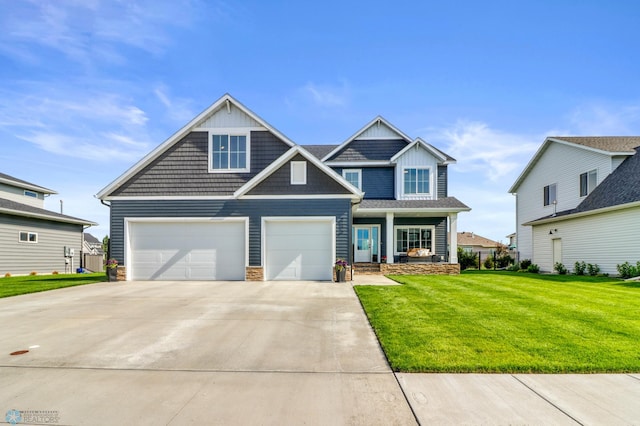 6176 Marigold Loop S, Fargo, ND 58104 - craftsman-style home featuring driveway, a front yard, an attached garage, and stone siding
