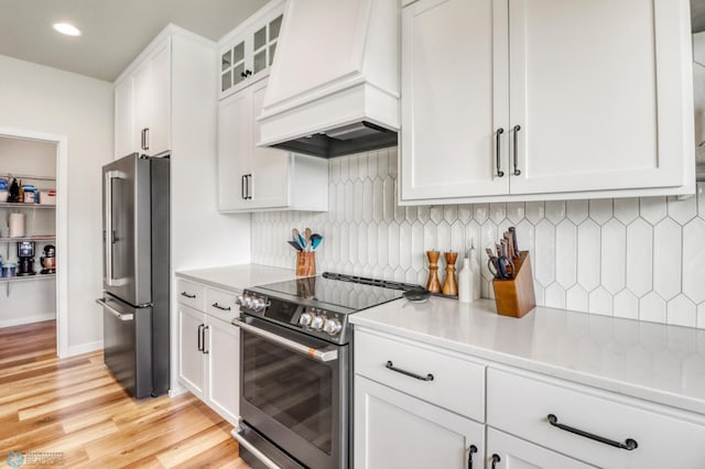 6176 Marigold Loop S, Fargo, ND 58104 - kitchen featuring stainless steel appliances, premium range hood, white cabinets, light wood-type flooring, and light countertops