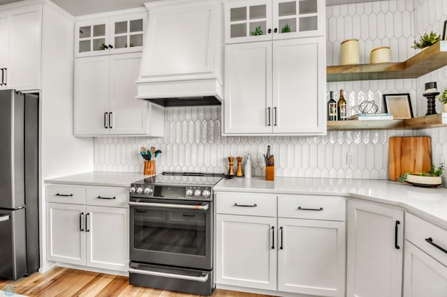 6176 Marigold Loop S, Fargo, ND 58104 - kitchen with appliances with stainless steel finishes, custom range hood, light countertops, tasteful backsplash, and white cabinetry