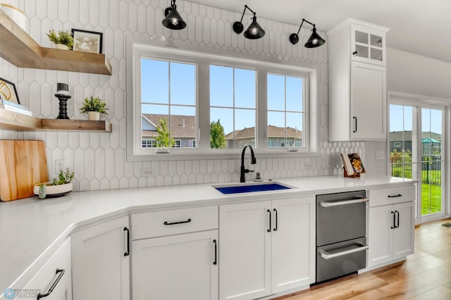 6176 Marigold Loop S, Fargo, ND 58104 - kitchen with open shelves, backsplash, white cabinets, light countertops, and glass insert cabinets