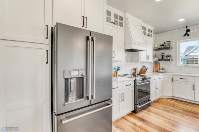 6176 Marigold Loop S, Fargo, ND 58104 - kitchen featuring stainless steel appliances, premium range hood, light countertops, light wood finished floors, and white cabinets