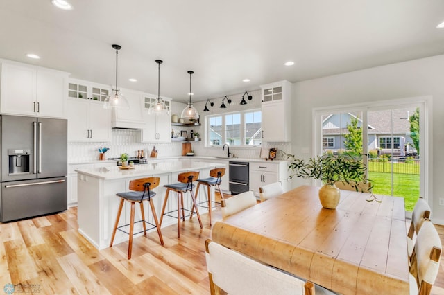 6176 Marigold Loop S, Fargo, ND 58104 - kitchen featuring high end refrigerator, a center island, a kitchen breakfast bar, backsplash, and light countertops