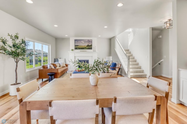 6176 Marigold Loop S, Fargo, ND 58104 - dining area with light wood-style floors, stairs, recessed lighting, and a fireplace
