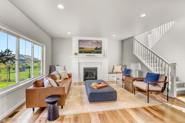 6176 Marigold Loop S, Fargo, ND 58104 - living area featuring light wood-style flooring, stairs, a fireplace, and recessed lighting